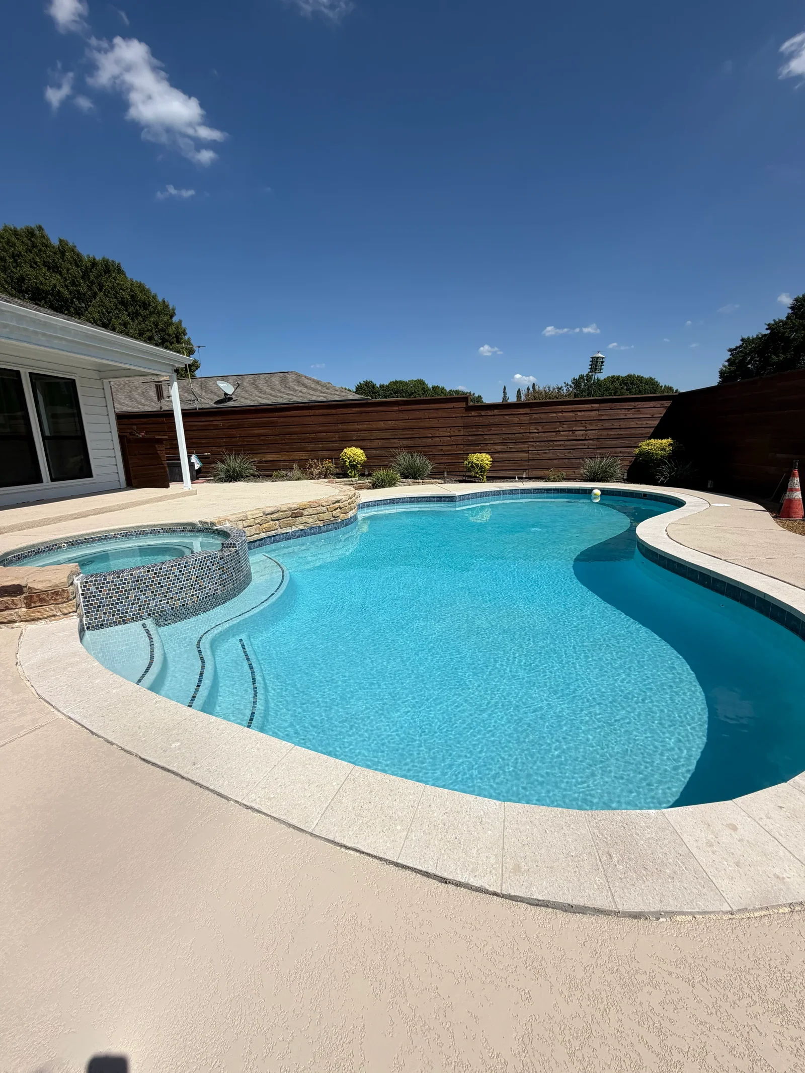 Pool repair technician performing leak detection on a residential pool